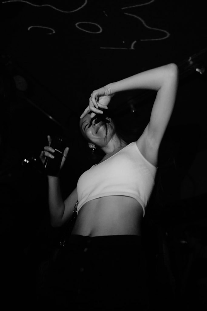 a black and white photo of a woman dancing